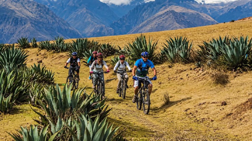 Mountain bikers descending an Andean trail on the Death Road tour from Cusco